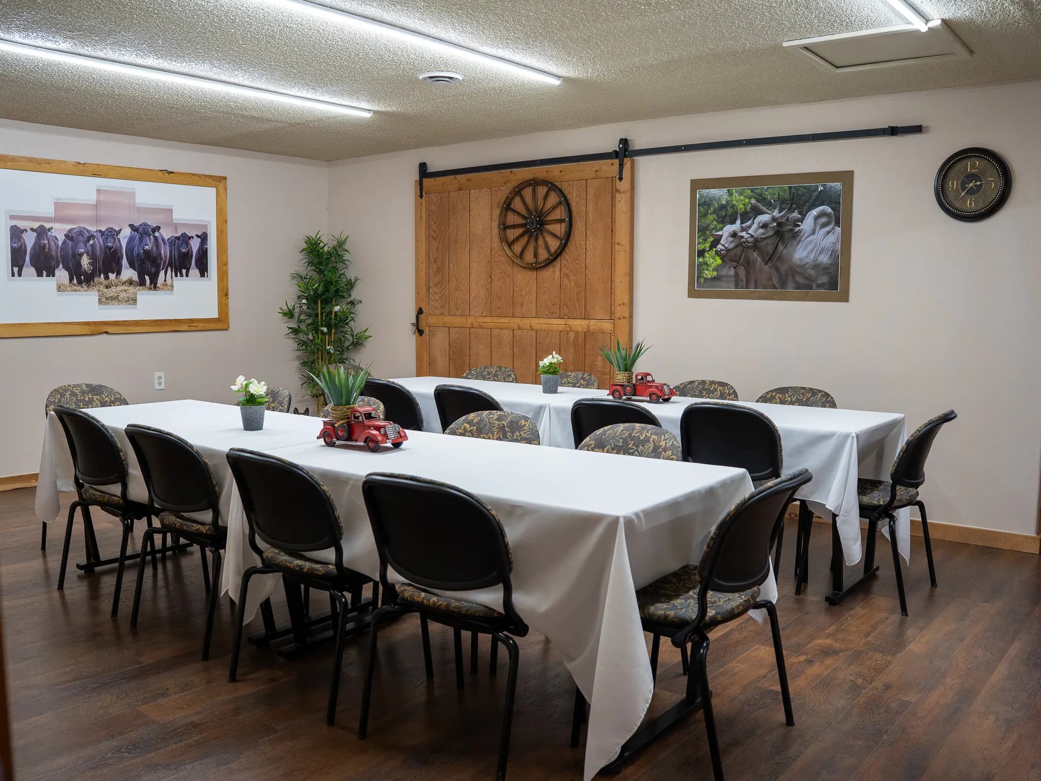 Boardroom set banquet-style with a barn door accent wall