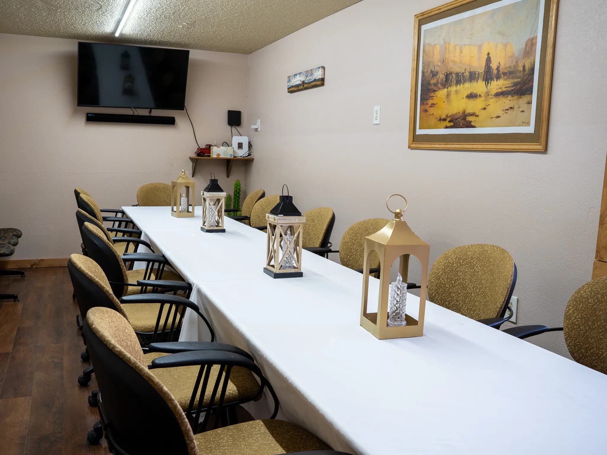 Long conference table styled with lantern centerpieces