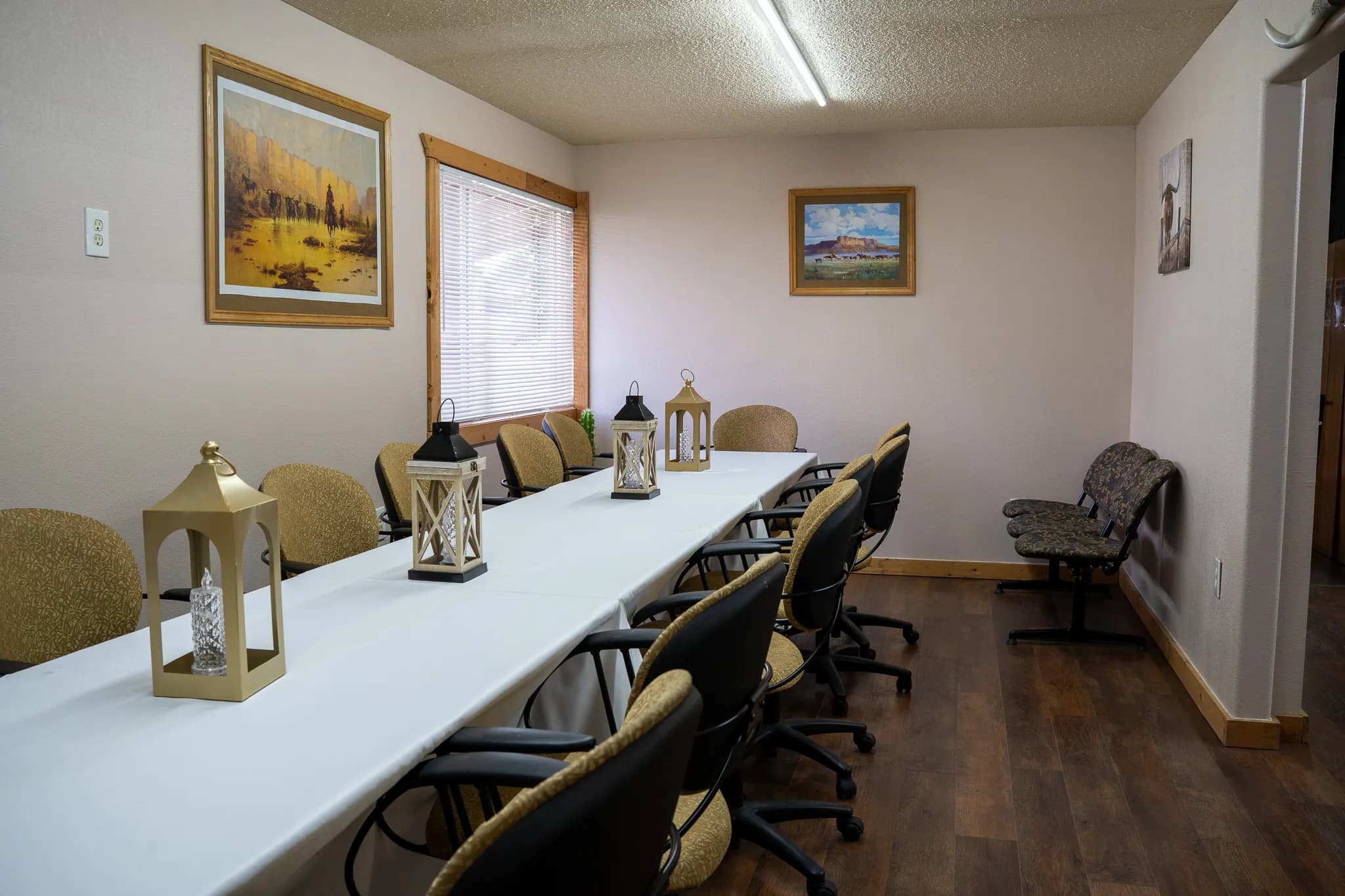 Private meeting room with framed art and lantern decor