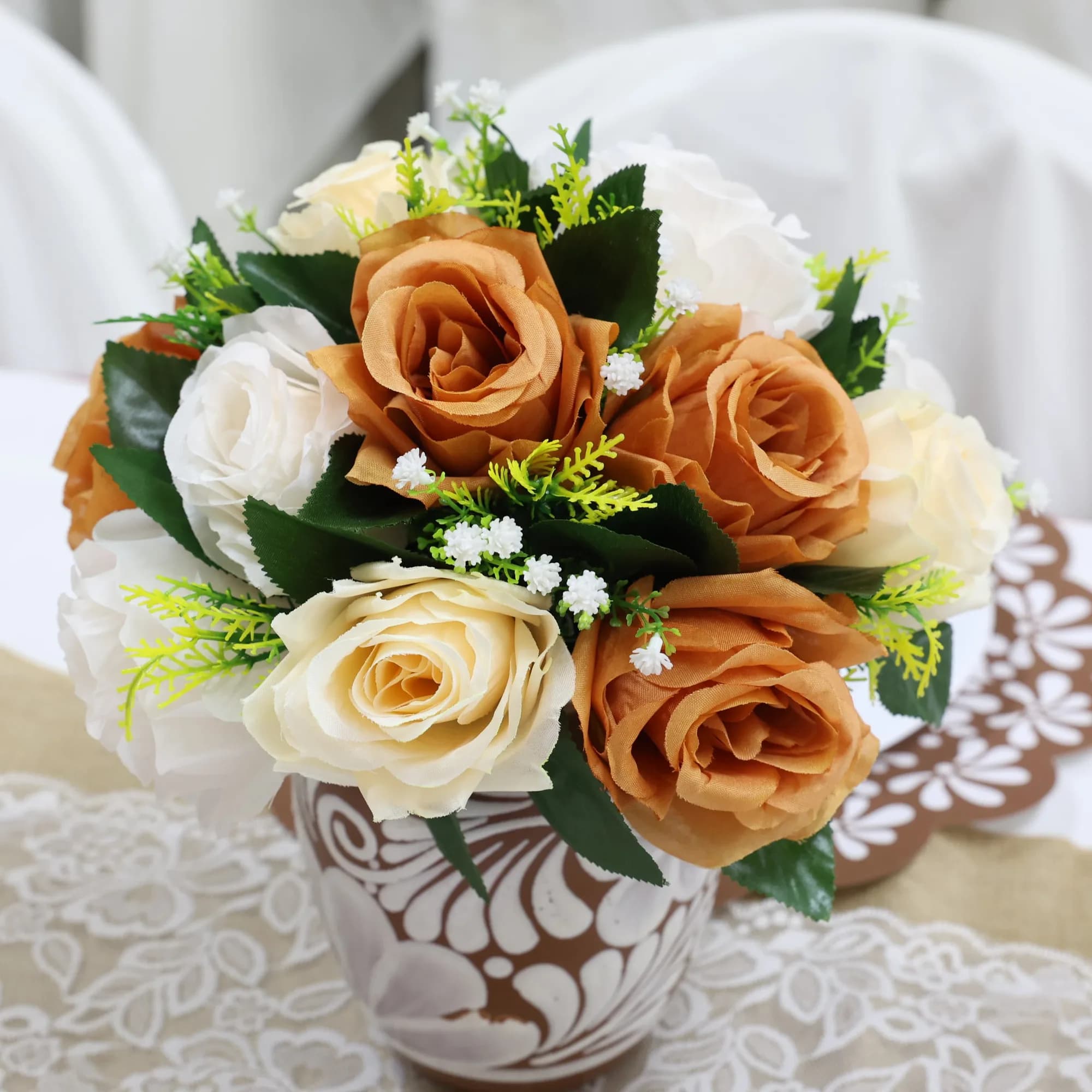 Rose bouquet centerpiece in a hand-painted vase