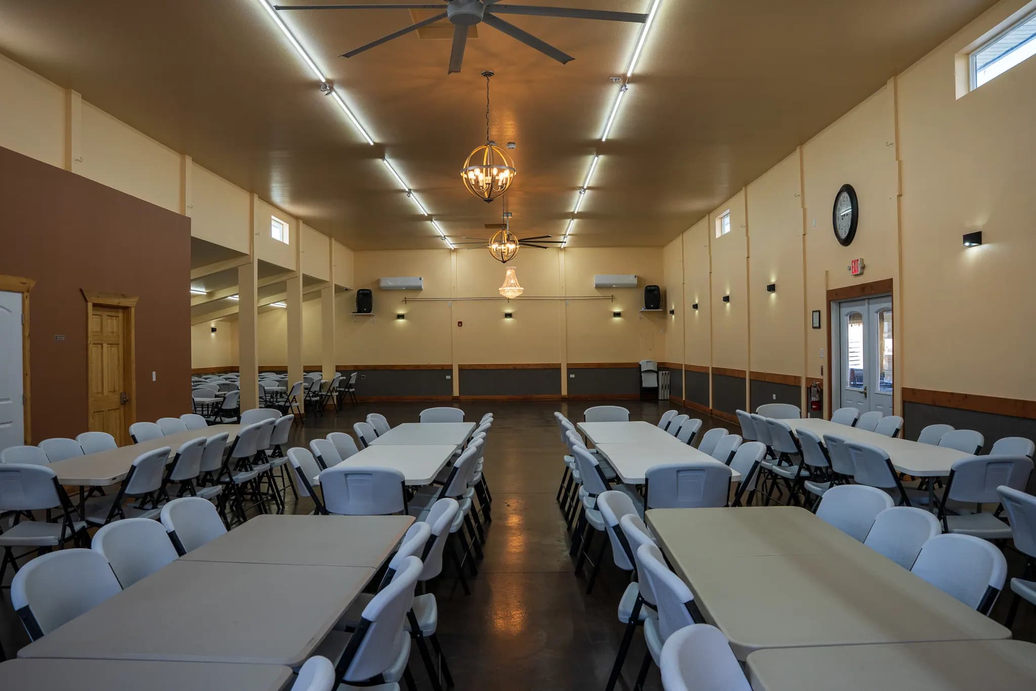 Grand Ballroom banquet hall with round tables beneath a crystal chandelier