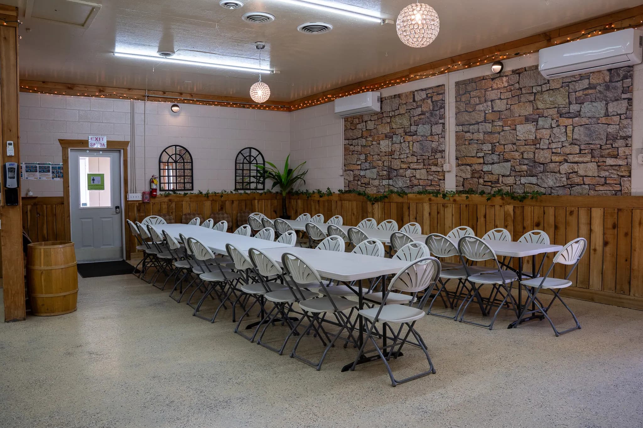 Mid-Size Hall party room with long tables beneath string lights